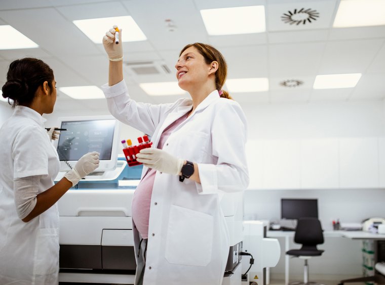 Pregnant scientist doing lab work