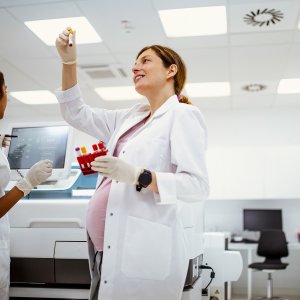 Pregnant scientist doing lab work