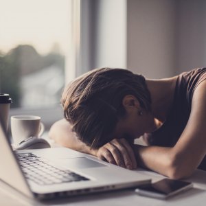 Exhausted student in front of laptop